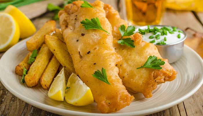 Plate of fried fish and chips at Spiros All Day Diner in Tooele Utah, served with dipping sauce.