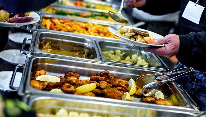 Guests enjoy breakfast at Spiros All Day Diner, serving themselves from the restaurant buffet.