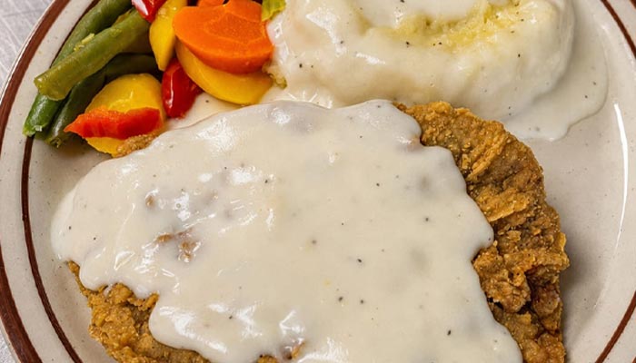 Chicken fried steak with white gravy, mashed potatoes, and veggies—Lunch and Dinner Menu Tooele UT.