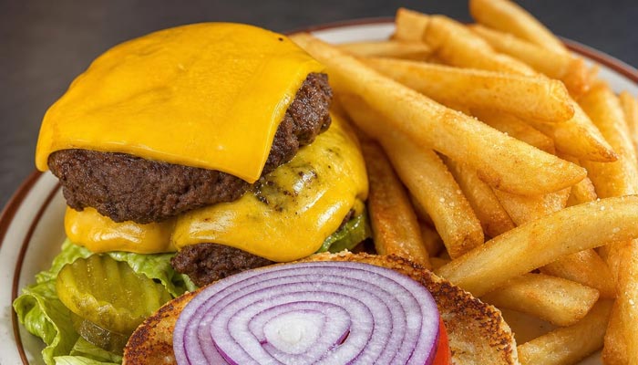 Cheeseburger with lettuce, pickles, onions, and tomato at our Breakfast Restaurant Tooele UT.