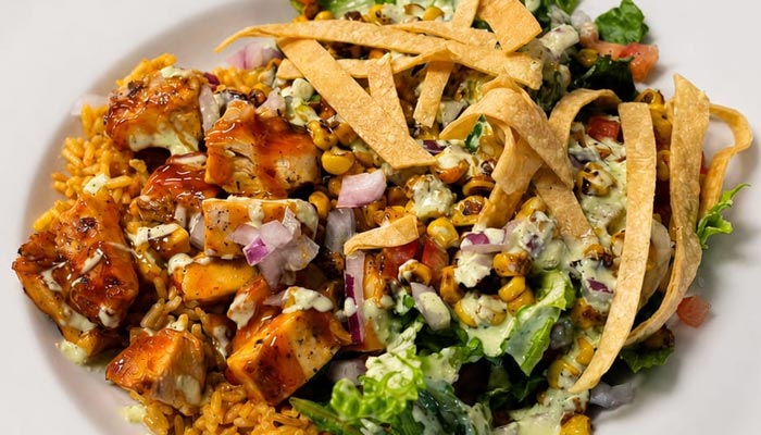 Grilled chicken on rice with corn salad, onions, tortilla strips—Lunch and Dinner Menu Tooele UT.